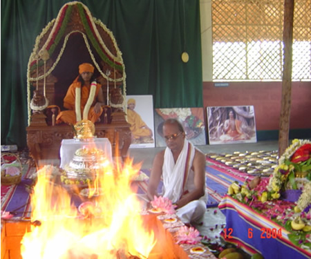17 - Paramahamsa Sri Nithyananda presides at the fire ritual being performed as part of the traditional coronation ceremony. The Kirita, golden crown and the Svarna Pad